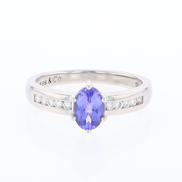 oval tanzanite ring with channel set diamonds on either side in white gold